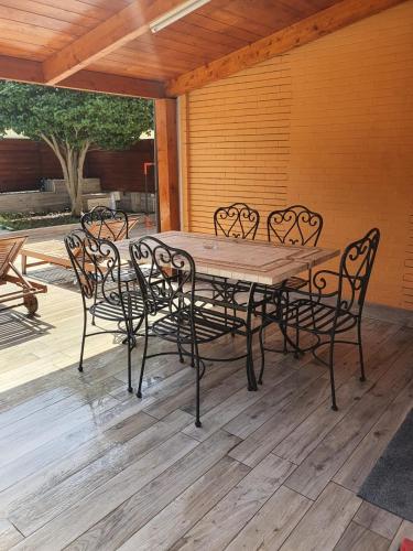 a wooden table and chairs on a patio at Villa Giulia in Pozzuoli