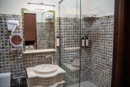 a bathroom with a sink and a shower at Kazma Boutique Hotel in Tbilisi City