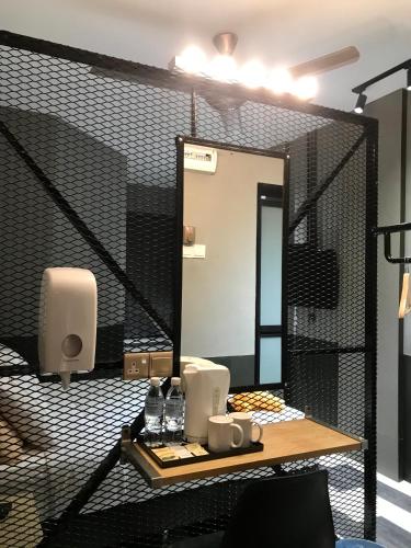 a bathroom with a large mirror and a sink at Kavy Boutique Hotel @ KBH in Brinchang