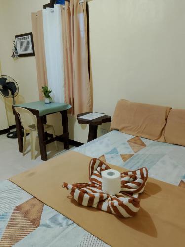 a room with a bed and a table with a cup on it at Subangan Veranda in Burgos