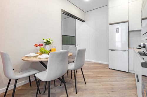a kitchen and dining room with a table and chairs at Republic Residence in Astana