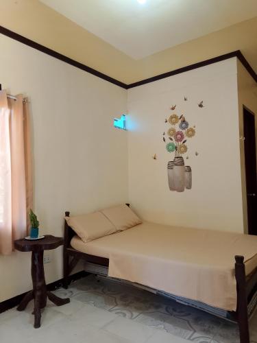 a bedroom with two beds and a table at Subangan Veranda in Burgos