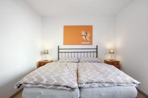 a bedroom with a large bed with two night stands at Ferienwohnung am Klemmbach in Müllheim