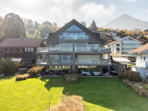 a large house with a large yard at Nautica Faulensee in Faulensee
