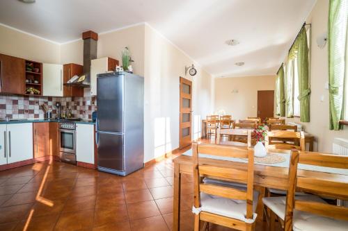 a kitchen and dining room with a stainless steel refrigerator at Penzion Fialka in Velké Losiny
