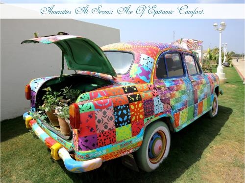 a colorful car painted like a truck parked on the grass at Serena Beach Resort in Mandvi