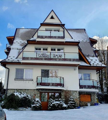 a building with a sign on the front of it at Willa Irys in Bukowina Tatrzańska