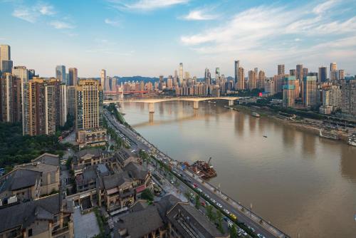 a view of a city with a river and a bridge at ChongQing BackHome Riverview Hotel in Chongqing