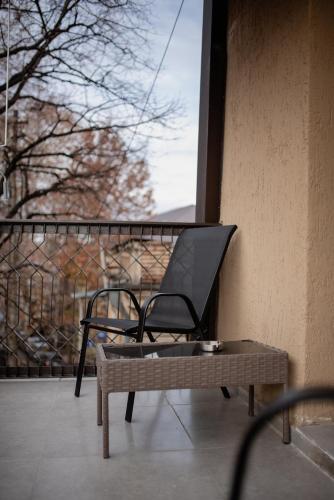 a chair sitting on a balcony next to a window at Kazma Boutique Hotel in Tbilisi City