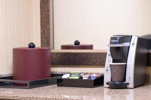 a coffee maker on a counter in a hotel room at Embassy Suites by Hilton Bloomington/Minneapolis in Bloomington