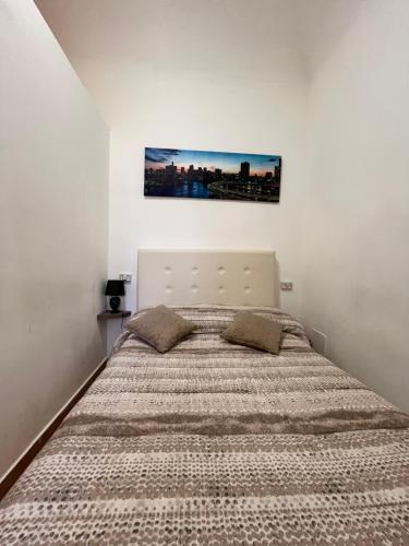 a bedroom with a large bed in a white room at House del Corso Calatafimi in Palermo