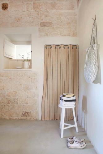 a room with a white table and a wooden wall at Villas with pool at Ostuni in Carovigno