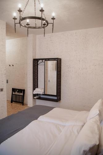 a bedroom with a bed and a mirror at Kazma Boutique Hotel in Tbilisi City
