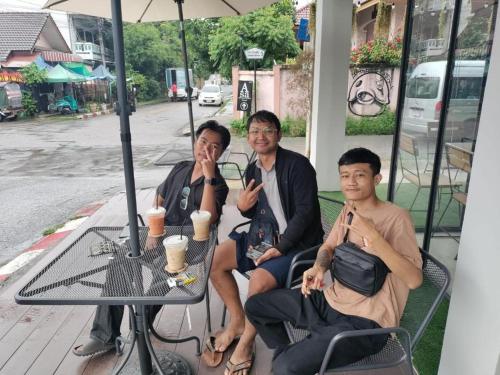 a group of three people sitting at a table at Lazy Gibbon 2 Chiang Mai - Haiya in Chiang Mai