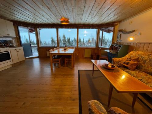 a living room with a couch and a table at Åre, Trillevallen stuga Emma in Undersåker