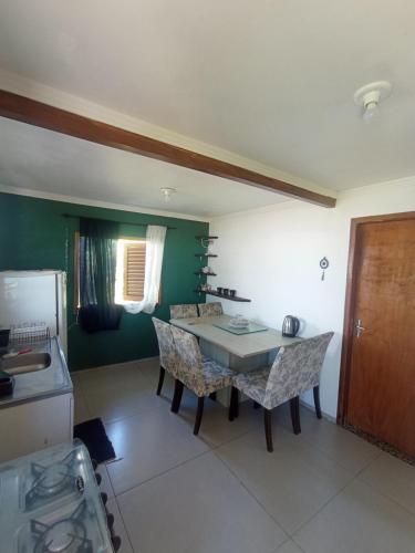 a kitchen with a table and chairs in a room at Casa na Beira da Praia de Capão da Canoa in Capão da Canoa