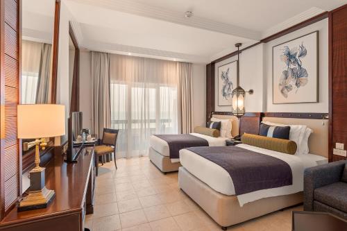 Una cama o camas en una habitación de Ajman Hotel & Villas by Blazon Hotels