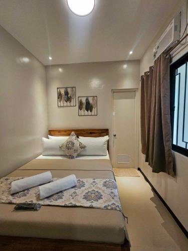 a bedroom with a bed with two towels on it at JaiJai's Backpackers Inn in Coron