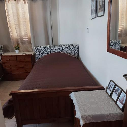 a small bed in a room with a mirror at Agrepavli Lapithia in Kallepia