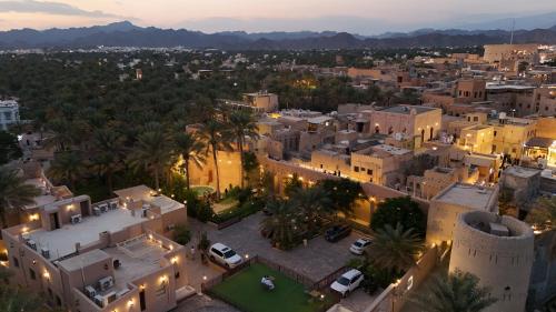 an aerial view of a city at night at نزل البستان Bustan lnn in Nizwa