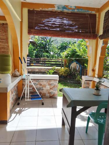 a kitchen with a counter and a table and a window at Subangan Veranda in Burgos