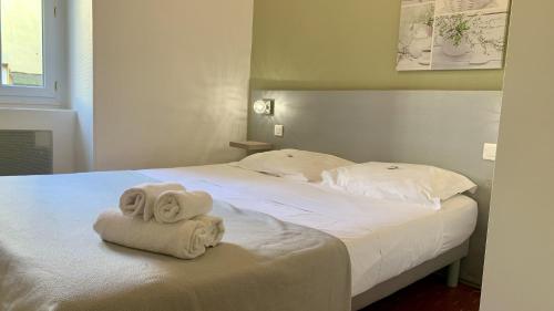 une chambre avec un lit avec des serviettes dessus dans l'établissement ApartHotel Riviera - COCON BARILLERIE - Old Town - Promenade des Anglais, à Nice