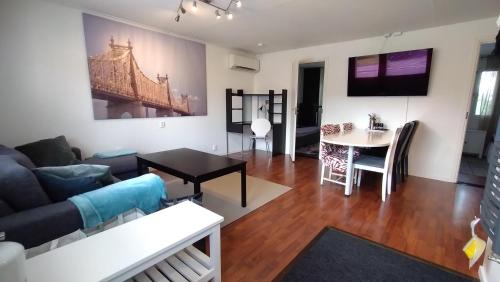a living room with a couch and a table at Nice apartment for 4, budget alternative for 7 in Haparanda