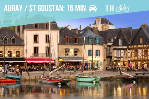 a city with boats in the water in front of buildings at Studio Cosy LES ROSES TREMIERES 3 étoiles centre Plouharnel proche mer in Plouharnel
