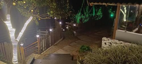 a stairway with lights on a house at night at The Mountain Shades Resort in Madikeri