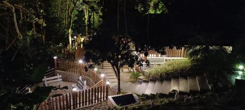 a view of a park at night with lights at The Mountain Shades Resort in Madikeri