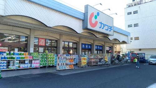 a store front of a shopping center with a store at OSO Homestay in Koshigaya