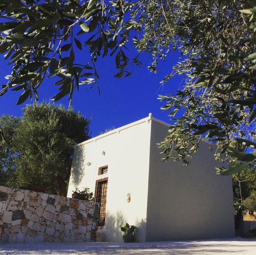a white building with a blue sky in the background at Casettina Matilda in Ostuni