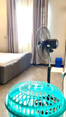 a table with a fan in a living room at Rebecca Apartments Kampala in Kampala