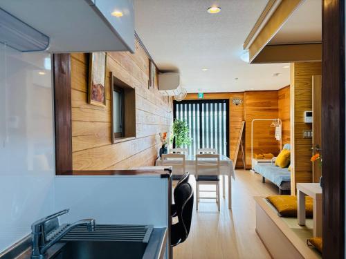 a kitchen and living room with a sink and a table at Lapis House 101 - 1F in Tokyo