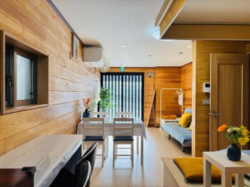 a kitchen and living room with a table and chairs at Lapis House 101 - 1F in Tokyo