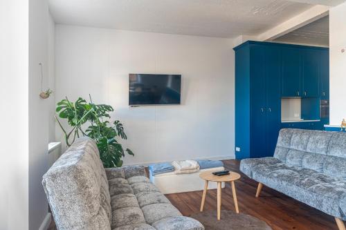una sala de estar con un sofá y una mesa en Maro Appartments, en Ypres