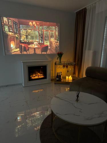 a living room with a fireplace and a table at HomeyHome Strasbourg in Schiltigheim