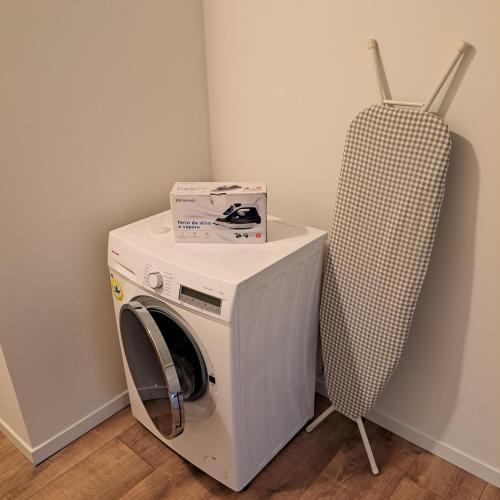 a washing machine with a box on top of it at Haus Am Schloss in Bleiburg