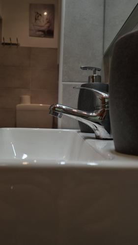 a bathroom sink with a faucet on top of it at Portside Inn in Genova