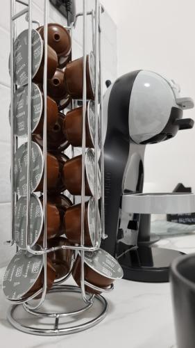 a bunch of donuts in a holder on a desk at Portside Inn in Genova