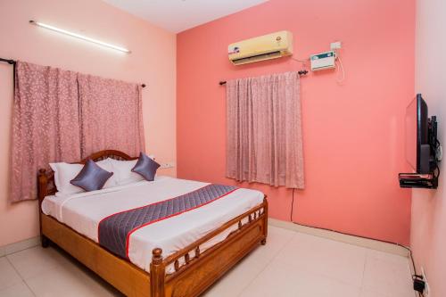 a bedroom with a bed and a television in it at HEAVEN PLEASANT STAy in Chennai