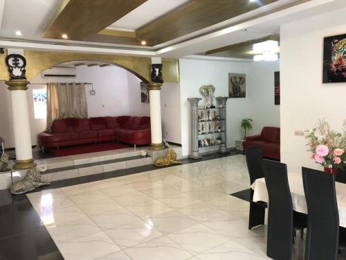 a living room with red couches and a table at Abidjan Cocody 3-Bed Apt - Sleeps 6 in Cocody