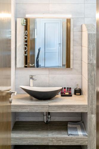a bathroom with a large sink and a mirror at Fiora Villas in Trapezaki