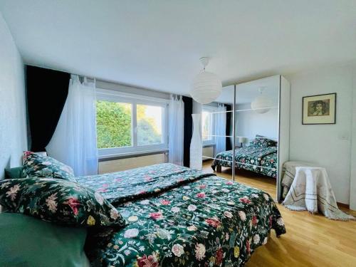 a bedroom with a bed and a large window at Seeblick Gwatt in Thun