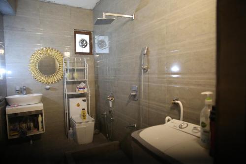 a bathroom with a sink and a toilet and a mirror at Karada Abu Nawas private room in Baghdad