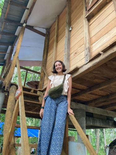 a woman sitting on top of a tree house at Sigiri Crown Tree Lodge in Sigiriya