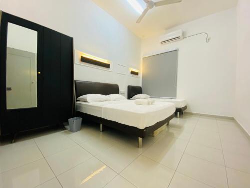 a bedroom with two beds and a mirror at Alyn Home Batu Pahat VII Netflix Wifi Coway in Batu Pahat
