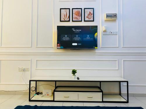 a living room with a tv on a wall at Alyn Home Batu Pahat VII Netflix Wifi Coway in Batu Pahat