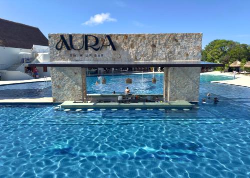 a pool at a resort with people in the water at Grand Sirenis Riviera Maya Resort & Spa All Inclusive in Akumal