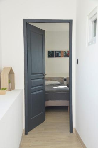 a door leading into a bedroom with a bed at Maison avec vue et sa piscine chauffée privative in Bessas